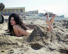 Edwige Fenech lies in sand on beach with feet in air 8x10 inch photo