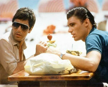 Scarface 1983 Steven Bauer Al Pacino sit having drinks outdoors 8x10 inch photo