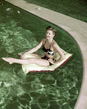 Barbara Stanwyck in black bikini on flotation device in her pool 8x10 inch photo