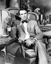 Gregory Peck stylish pose holding cigarette seated in chair in suit 8x10 photo