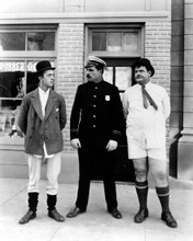 Laurel and Hardy stand without pants on next to policeman 11x17 Poster