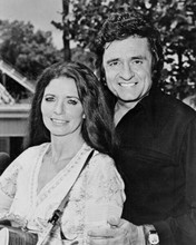 Johnny Cash poses with June Carter Cash with guitar 1978 Poster 16x20 inches