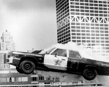 The Blues Brothers classic police car in mid-air smashes barrier 8x10 photo