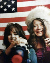 Janis Joplin & Grace Slick circa 1967 smile in front of American flag 8x10 photo