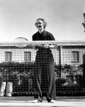 Bette Davis pictured in 1930's in black outfit playing tennis 8x10 inch photo