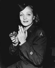 Marlene Dietrich smiling in military uniform lighting cigarette 8x10 inch photo