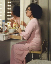 Elizabeth Taylor in pink robe sitting at her dressing table 8x10 inch photo