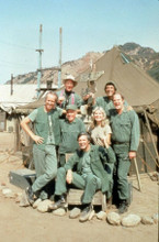M.A.S.H Alan Alda poses with cast with direction signs and tent in background