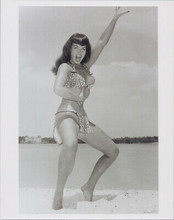 Bettie Page full length pose on beach in leopard skin Tarzan style bikini