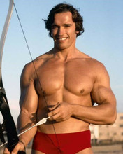 Arnold Schwarzenegger beefcake pose bare chested with bow and arrow 8x10 photo