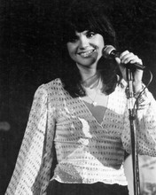 Linda Ronstadt young smiling pose 1970's on stage at microphone 8x10 inch photo