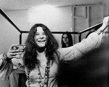 Janis Joplin holds up glass of champagne in scene from 1975 Janis 8x10 photo