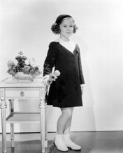 Shirley Temple holding flowers in coat and hat 8x10 inch photo