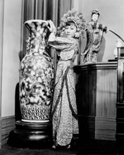 Anna May Wong stands by tall Chinese vase in period costume 8x10 inch photo