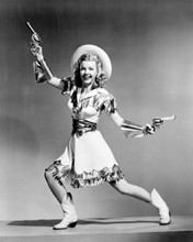 Dale Evans in cowgirl dress and boots holding two guns 8x10 inch photo