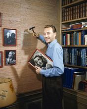 Paul Henreid 1940's smiling as he puts up photos in his study 8x10 inch photo