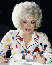 Dolly Parton 1980's in colorful blouse sitting with cup of tea 8x10 inch photo