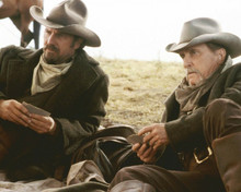 Open Range Kevin Costner & Robert Duvall play cards leaning on saddle 8x10 photo
