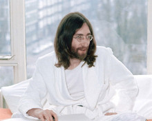 John Lennon classic 1970's in white robe sitting on bed 8x10 inch photo