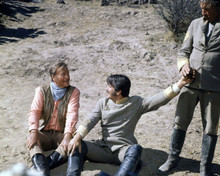 The Undefeated 1969 John Wayne & Rock Hudson sit on ground 8x10 inch photo