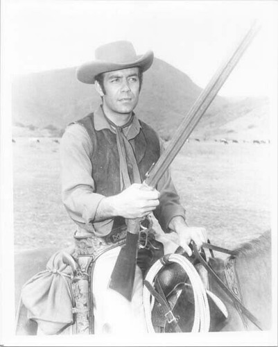 Pernell Roberts holds rifle on horseback on Ponderosa Ranch Bonanza ...