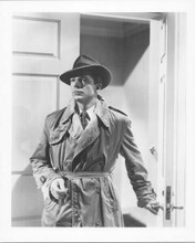 Dana Andrews in trenchcoat and hat enters room film noir Laura