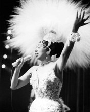 Josephine Baker in sequined gown & head dress on stage singing 8x10 inch photo