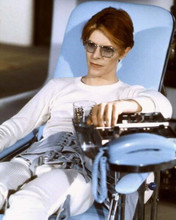 The Man Who Fell To Earth 1976 David Bowie sits in chair with drink 8x10 photo