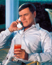 Larry Hagman sits on Southfork patio on phone with drink Dallas 8x10 photo