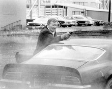 John Wayne aims his gun on roof of Pontiac Firebird Trans Am 1974 McQ 8x10 photo