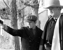 The Shootist 1976 John Wayne watches as Ron Howard fires gun 8x10 inch photo