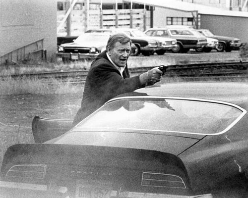 John Wayne takes aim with gun over his Pontiac Grand-Am 1974 McQ 8x10 ...