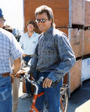 Richard Dean Anderson on bicycle chats with crew MacGyver 8x10 inch photo
