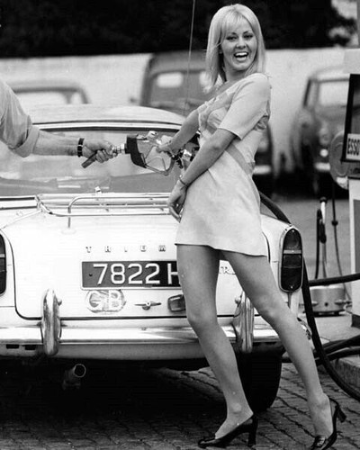 Yutte Stensgaard clowns with gas pump fueling her Triumph TR6 8x10 inch ...