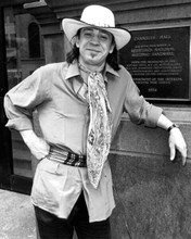 Steve Ray Vaughan smiles posing next to Carnegie Hall 8x10 inch photo
