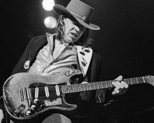 Stevie Ray Vaughan on stage performing playing his guitar 8x10 inch photo