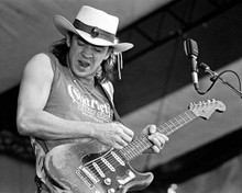 Stevie Ray Vaughan in full swing playing his guitar 8x10 inch photo