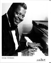 Oscar Peterson jazz legend smiles as he sits at piano 8x10 inch photo