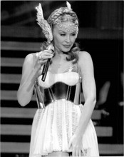 Kylie Minogue holds microphone performing on stage 2011 8x10 inch press photo