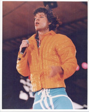 Mick Jagger in orange jacket on stage performing vintage 8x10 inch photo