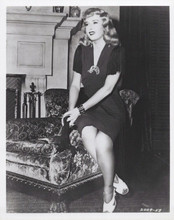 Barbara Stanwyck sits on edge of chair in living room 1940's 8x10 inch photo