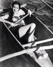 Maria Montez in Hawaiian style outfit lies in canoe 8x10 inch photo