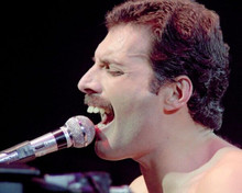 Freddie mercury seated at piano bare chested singing into microphone 8x10 photo