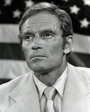 Charlton Heston 1970's in suit & tie in front of American flag 8x10 inch photo