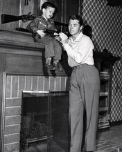 Audie Murphy at home with his son and gun collection 8x10 inch photo