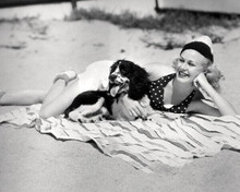 Jean Harlow lying on beach in swimsuit with her dog 8x10 inch photo