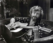 Kris Kristofferson strums guitar seated on sofa 1977 A Star is Born 8x10 photo