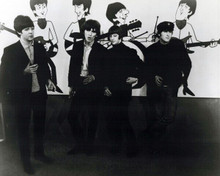 The Beatles pose in front of their cartoon animated characters 8x10 inch photo