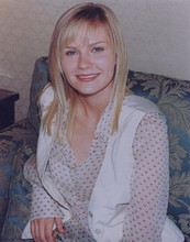 Kirsten Dunst seated on sofa smiles for press 1990's vintage 8x10 inch photo