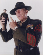 R. Lee Ermey holds up Full Metal Jacket action figure vintage 8x10 inch photo